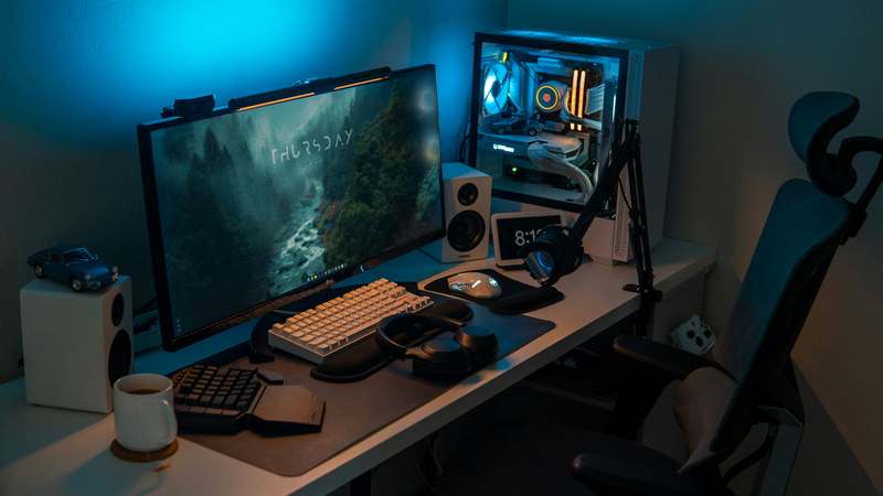 Professional gamer using a high-end PC gaming controller on a dark-themed gaming setup with RGB lighting